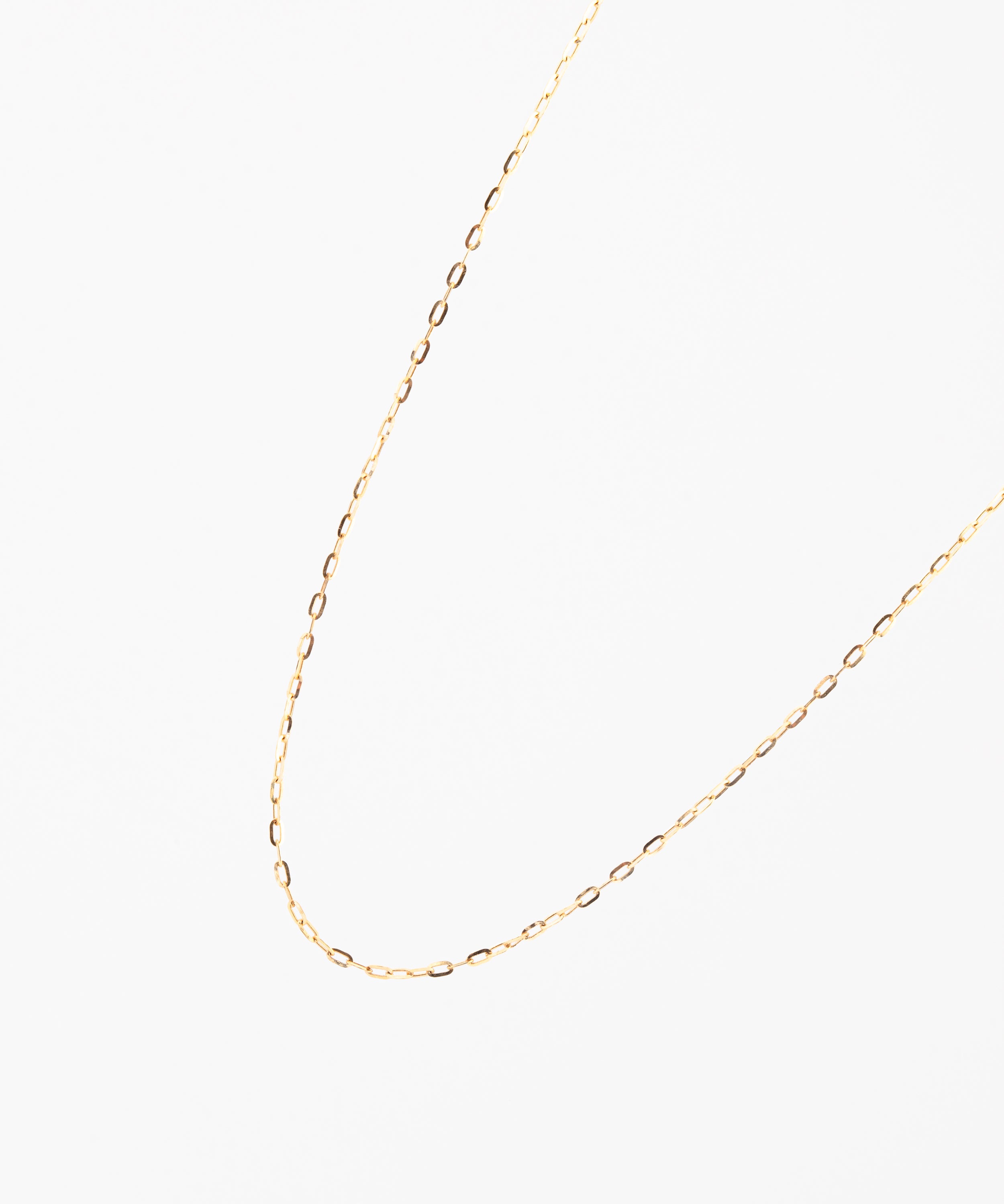 Gold chain necklace on a white background